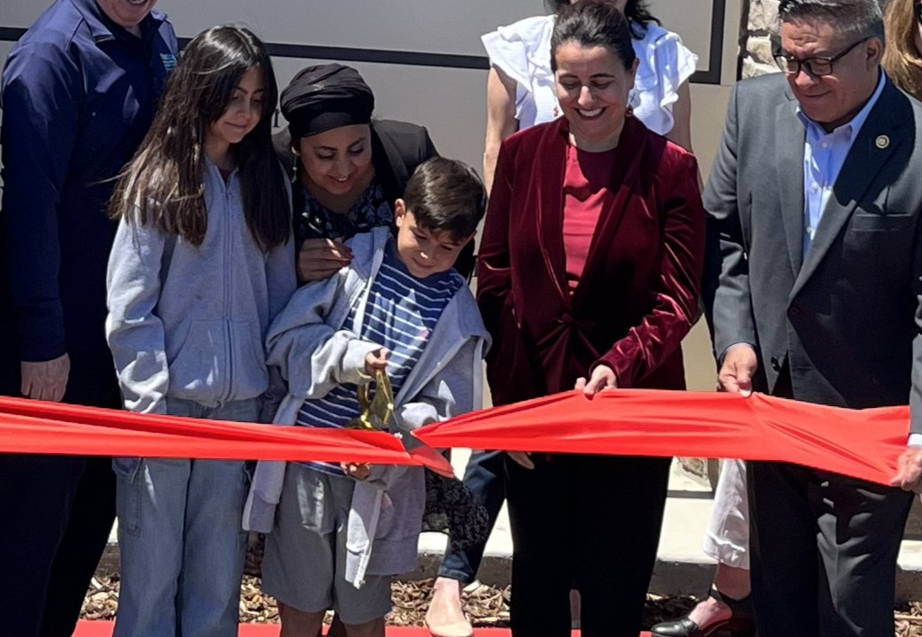 Young member of the Escalante family cuts the ribbon at a celebration on July 11, 2025.