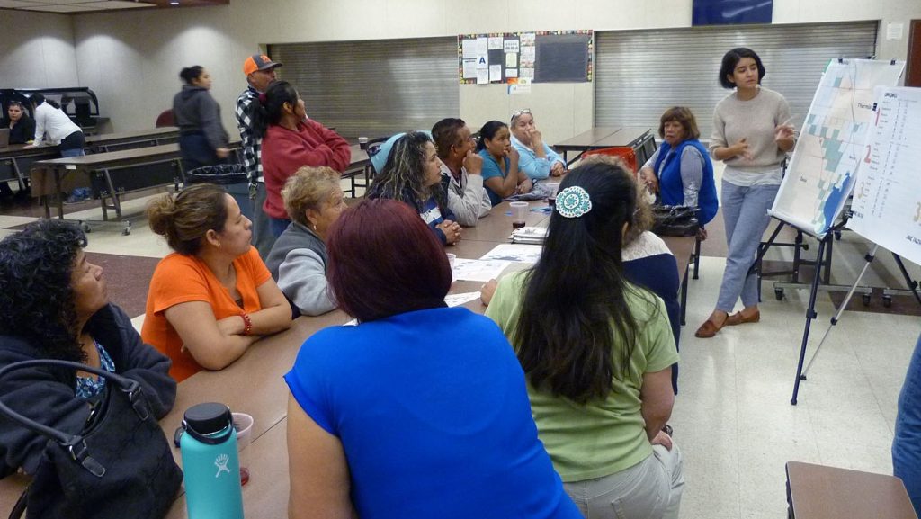 A group of people looking at a project map at a workshop.
