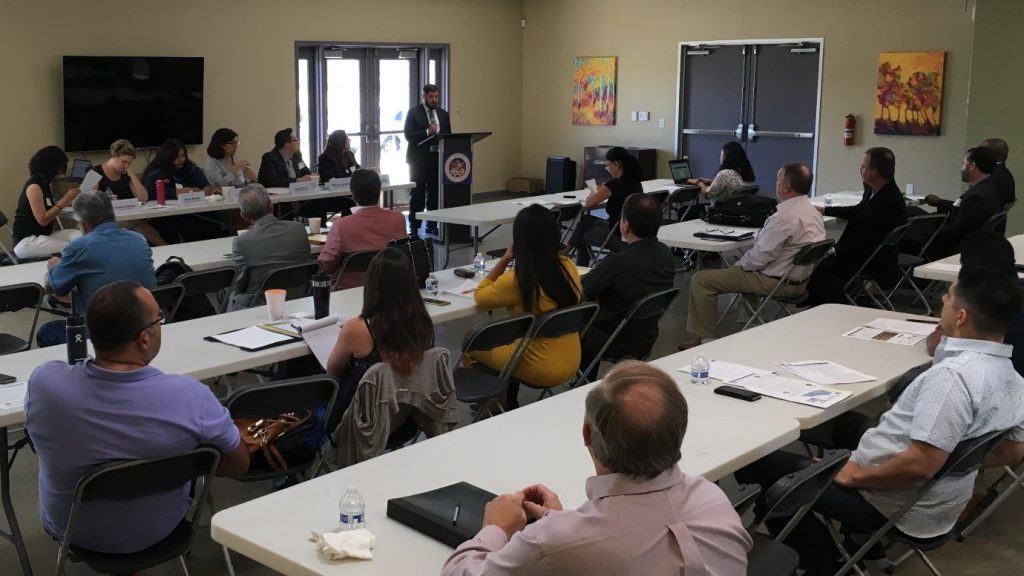 A workshop with people watching a panel discussion.